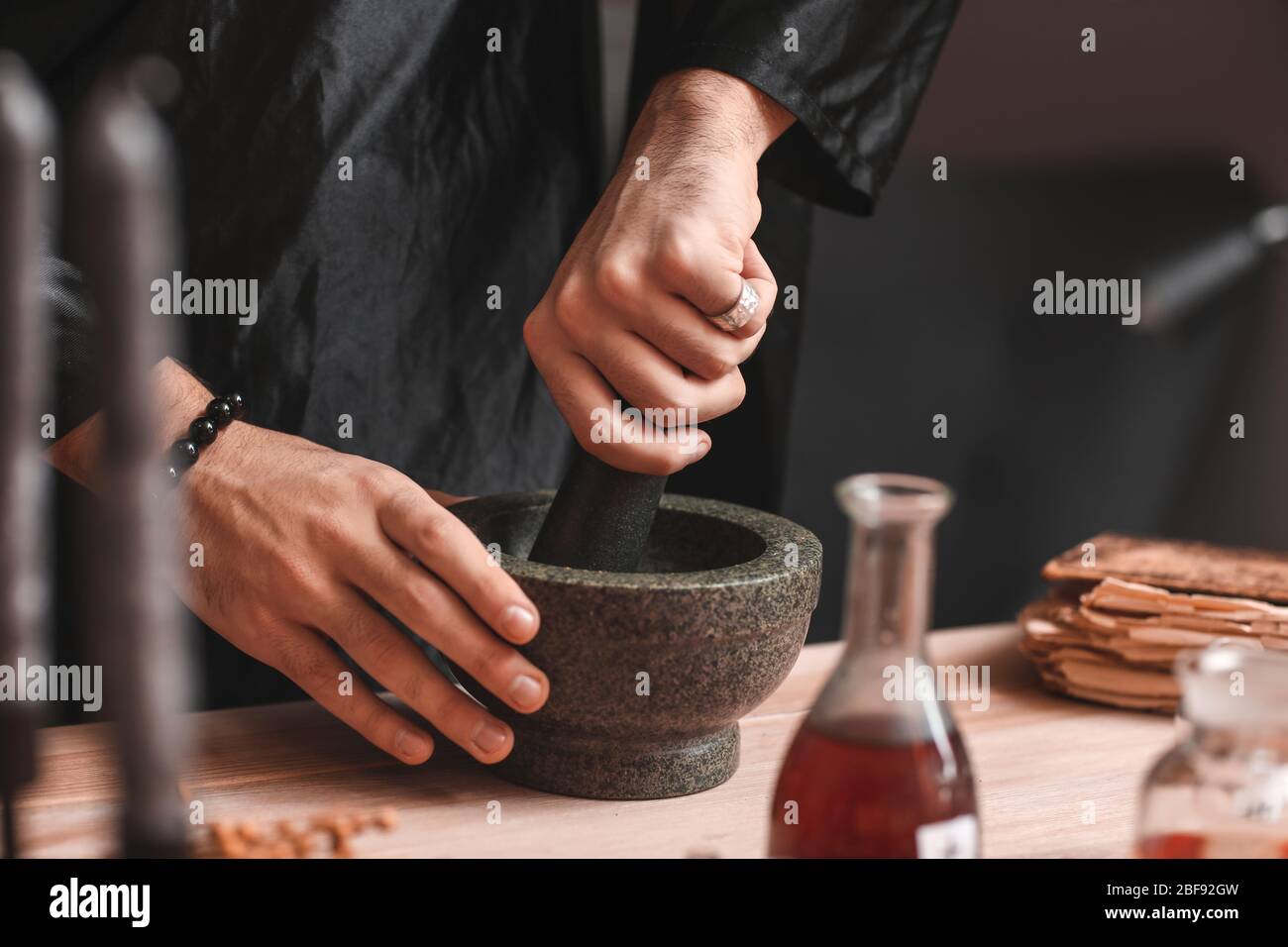 Male alchemist making elixir in laboratory, closeup Stock Photo