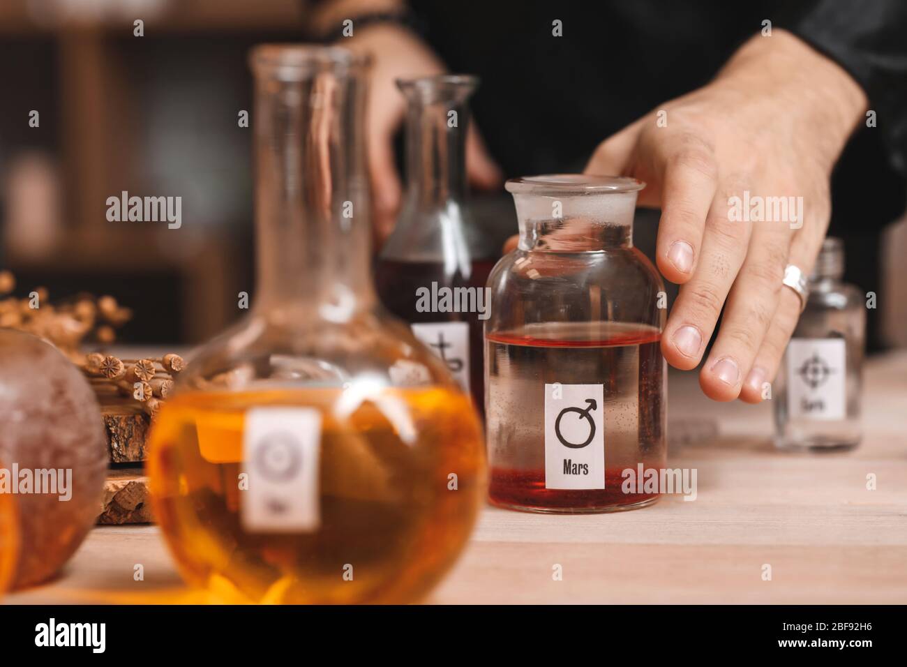 Male alchemist making elixir in laboratory, closeup Stock Photo