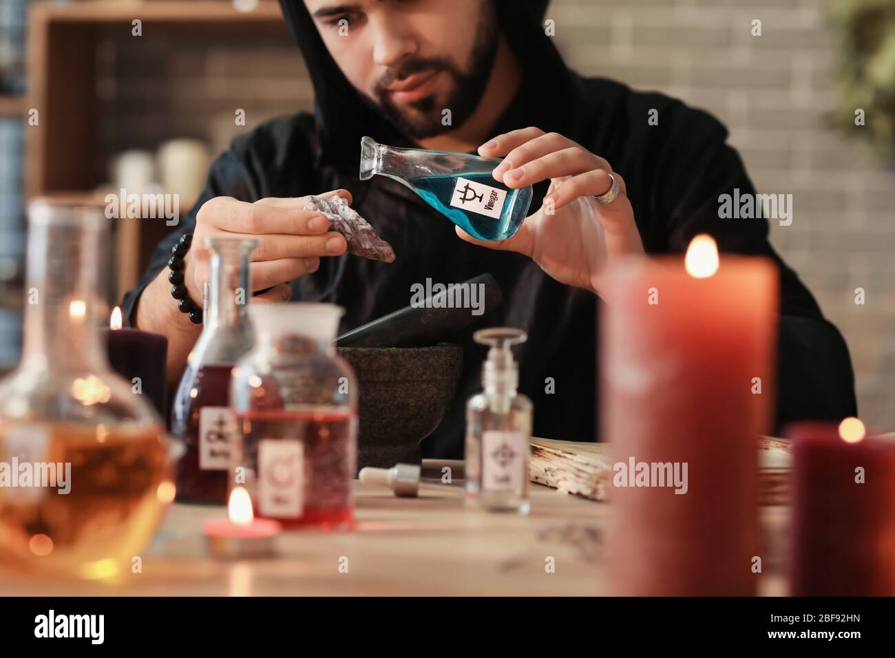 Male alchemist making elixir in laboratory Stock Photo