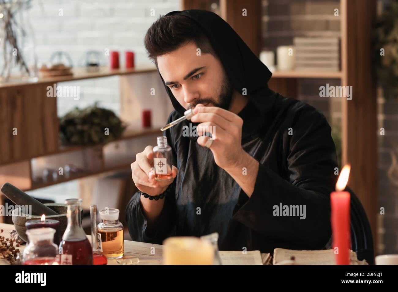 Male alchemist making elixir in laboratory Stock Photo