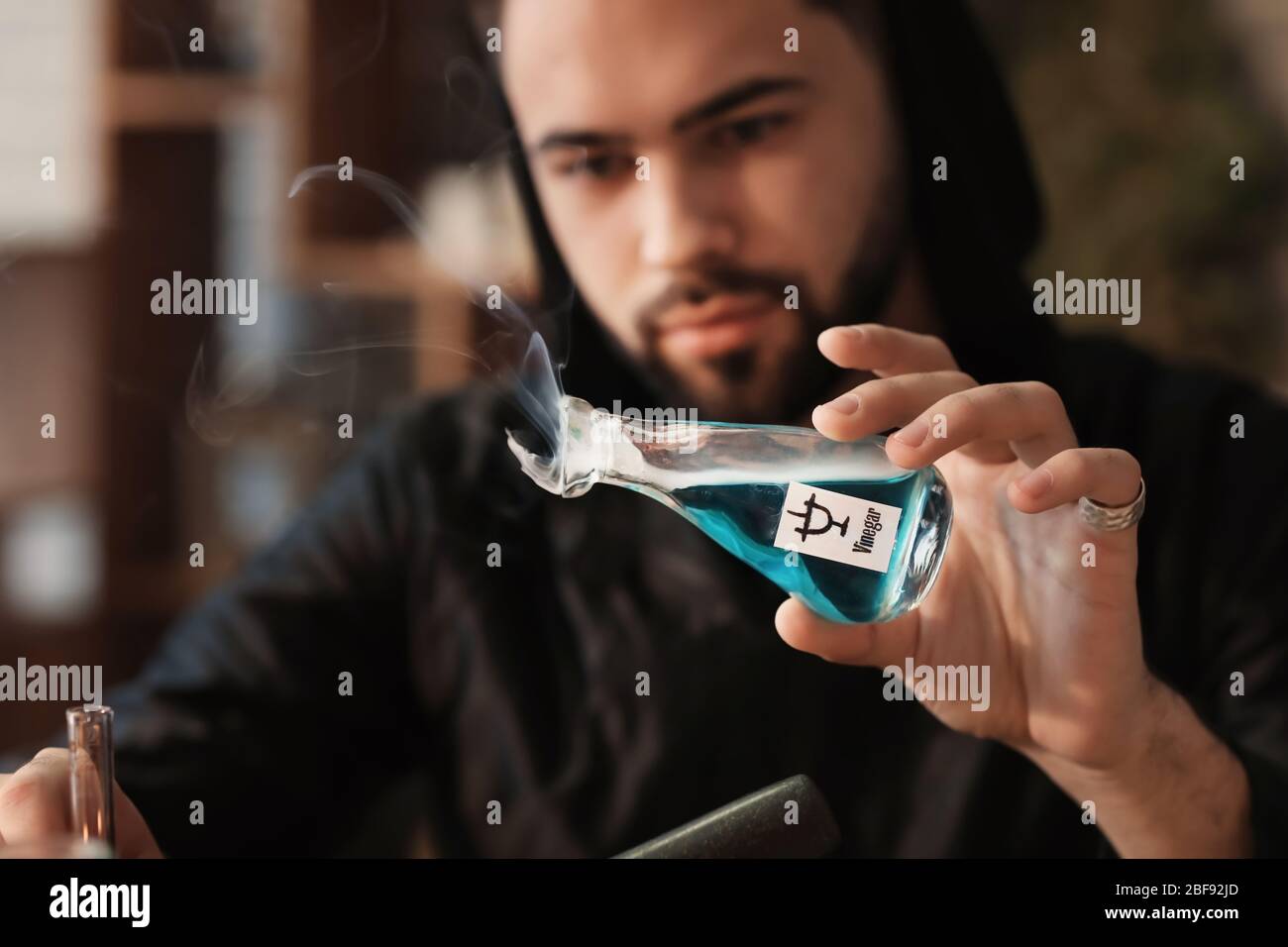 Male alchemist making elixir in laboratory Stock Photo