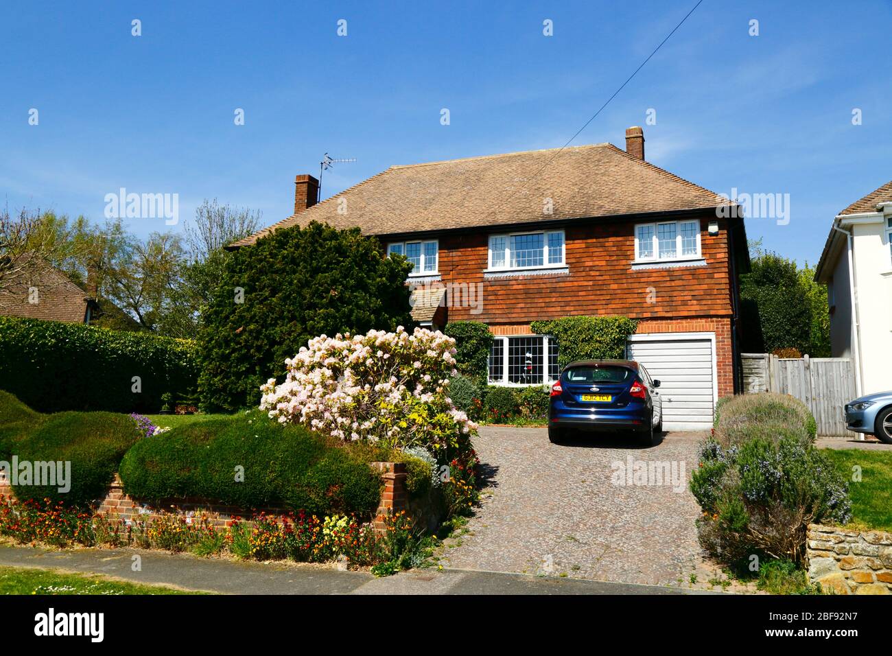 Car parked in drive of detached house on upmarket housing estate in spring, Southborough, Kent, England Stock Photo
