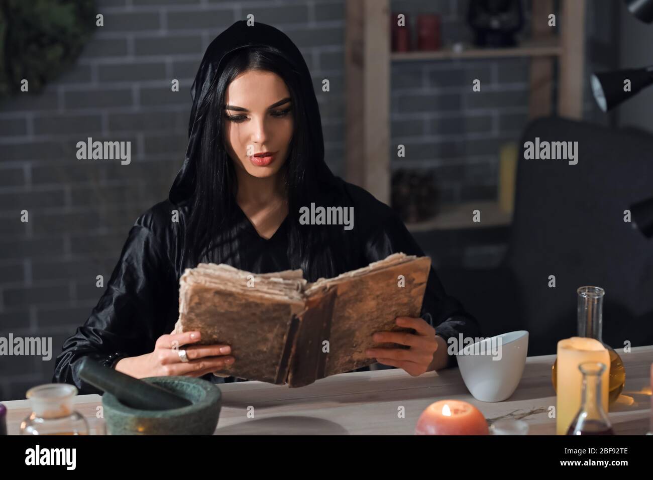 Female alchemist making elixir in laboratory Stock Photo