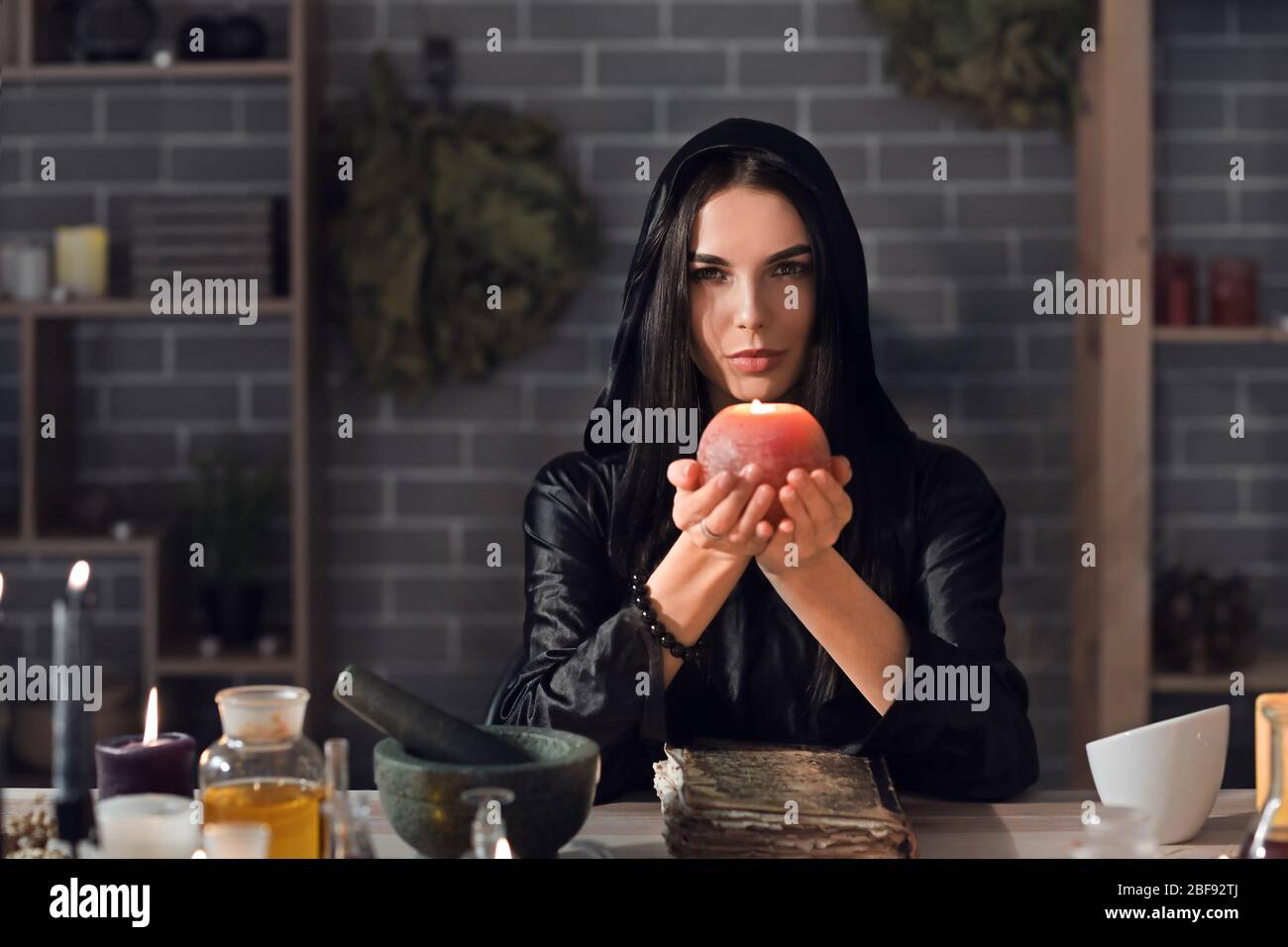 Female alchemist making elixir in laboratory Stock Photo