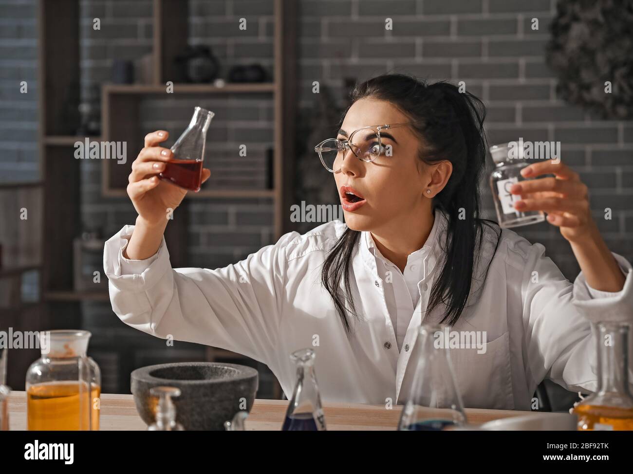 Crazy alchemist working in laboratory Stock Photo