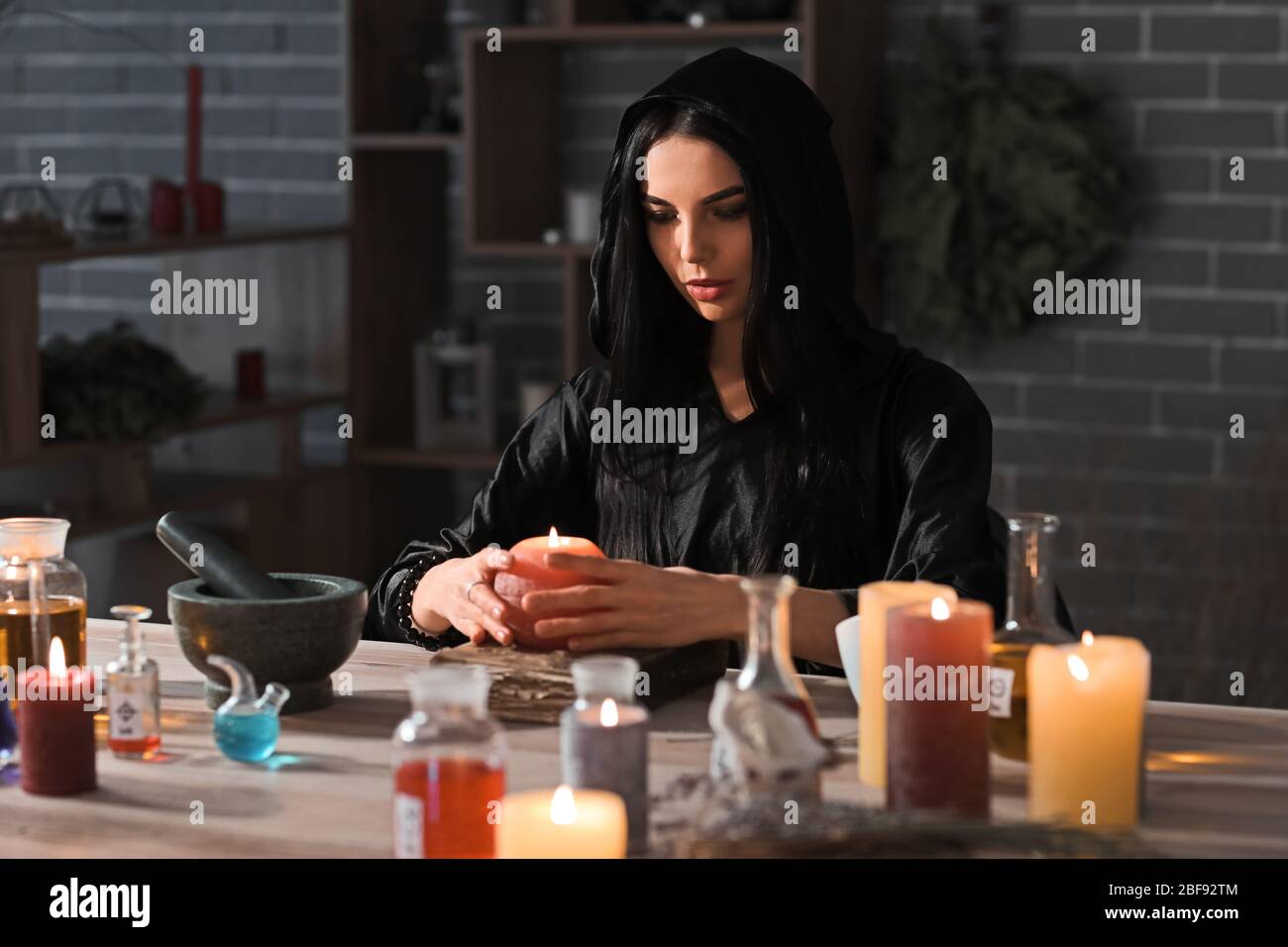 Female alchemist making elixir in laboratory Stock Photo
