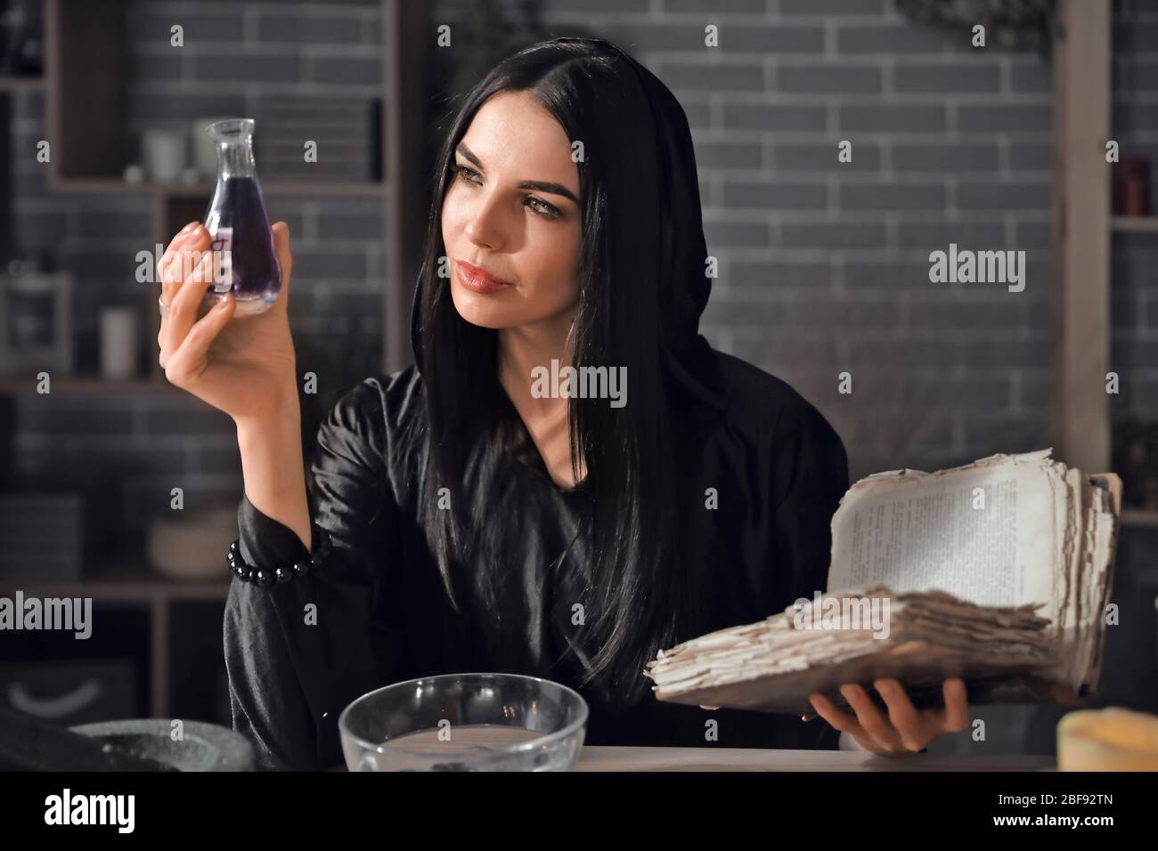 Female alchemist making elixir in laboratory Stock Photo