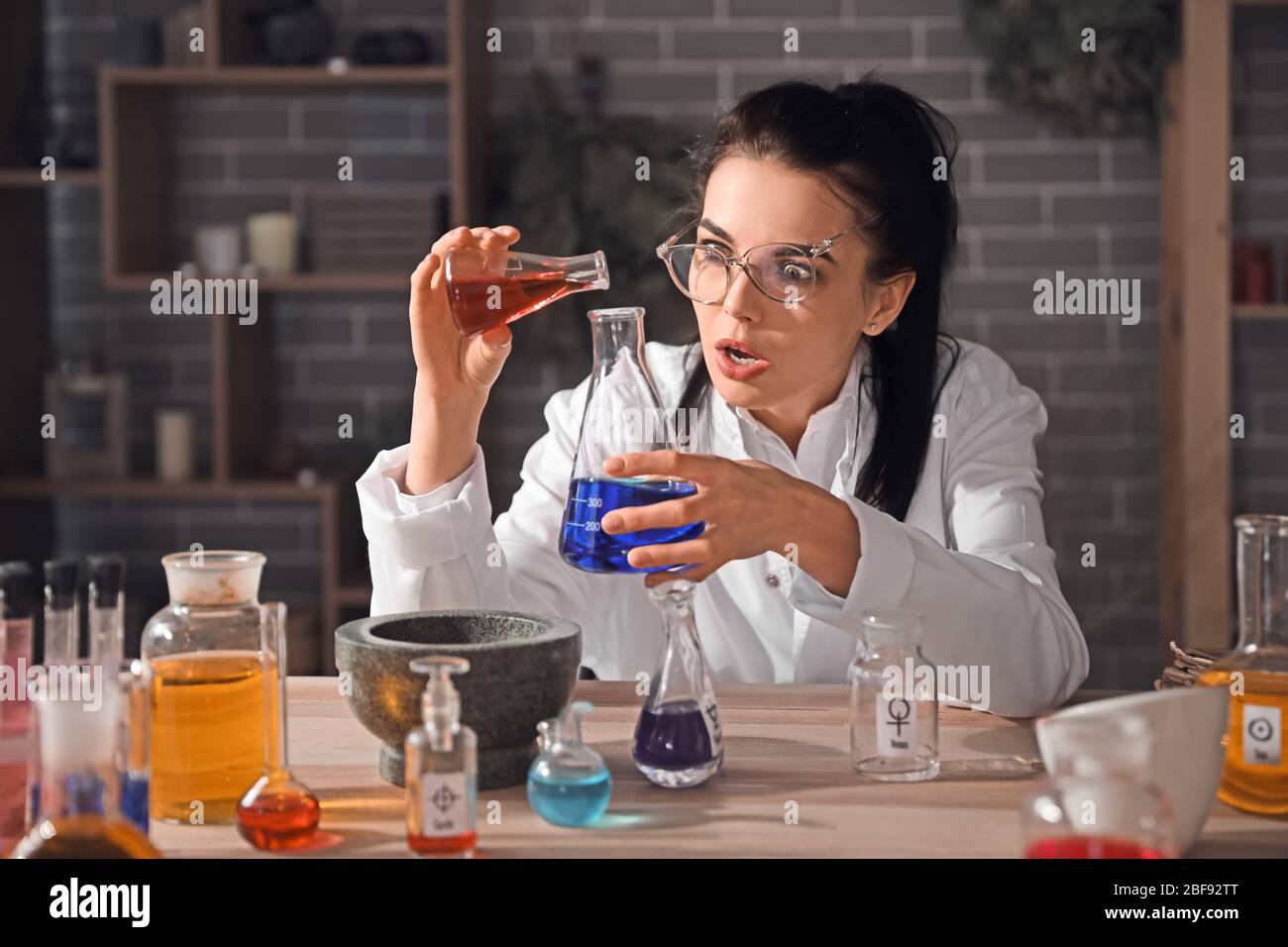 Crazy alchemist working in laboratory Stock Photo