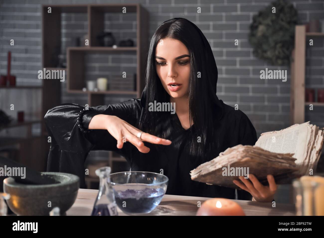 Female alchemist making elixir in laboratory Stock Photo