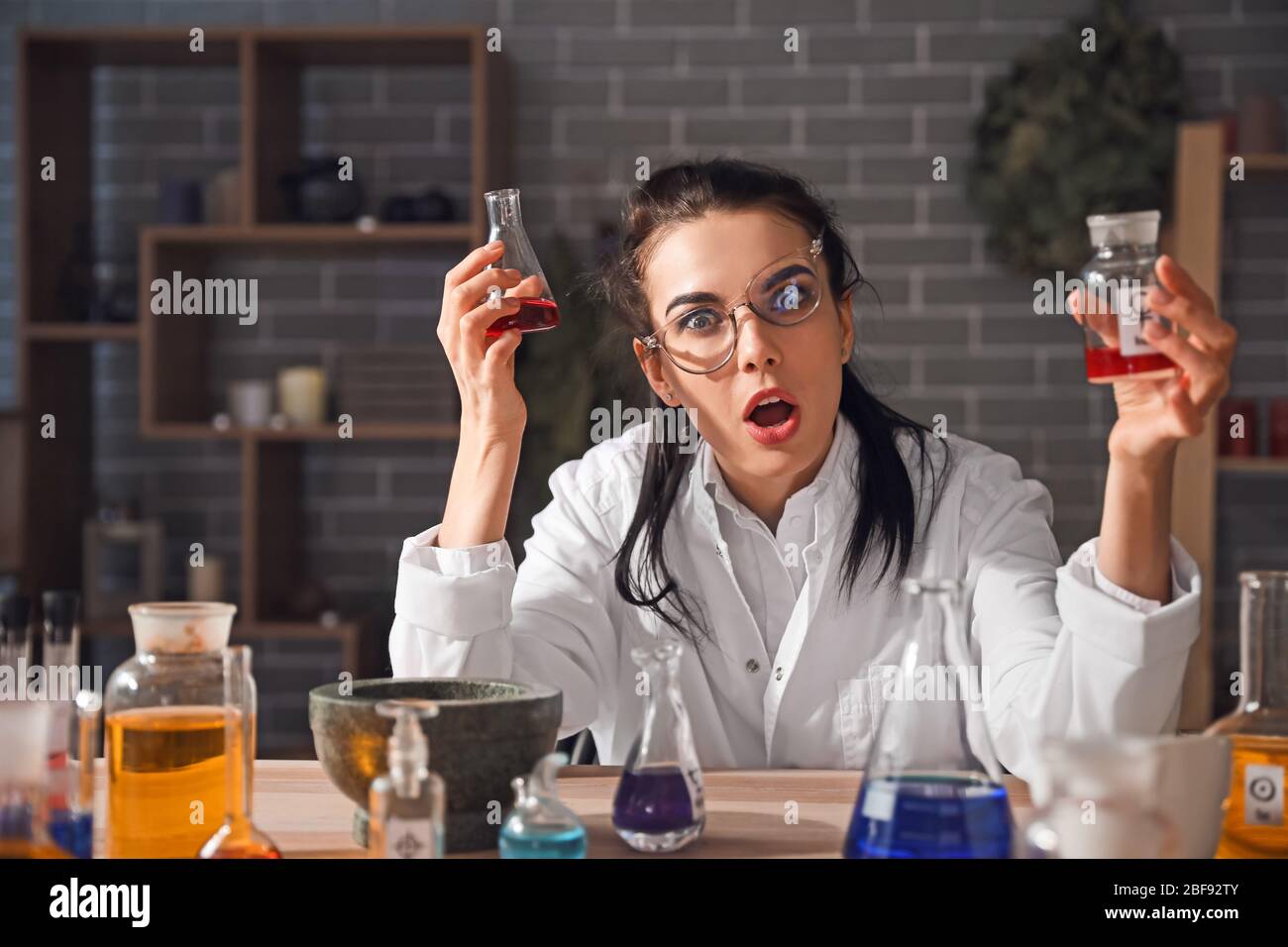 Crazy alchemist working in laboratory Stock Photo