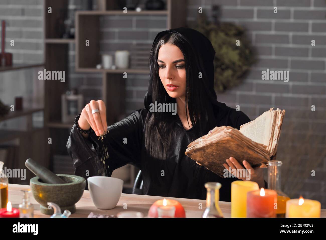 Female alchemist making elixir in laboratory Stock Photo