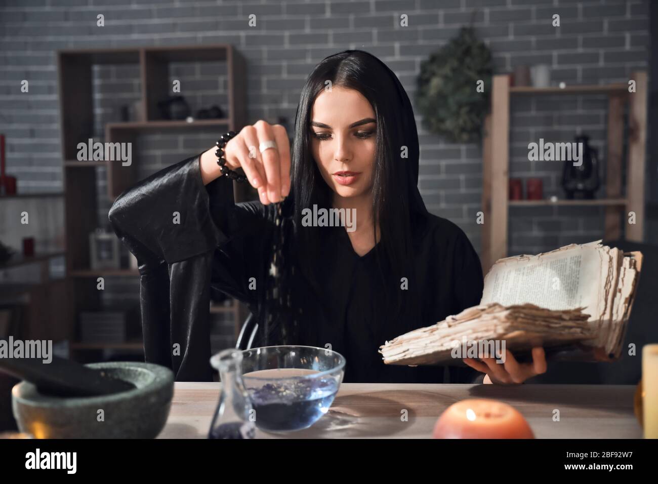Female alchemist making elixir in laboratory Stock Photo