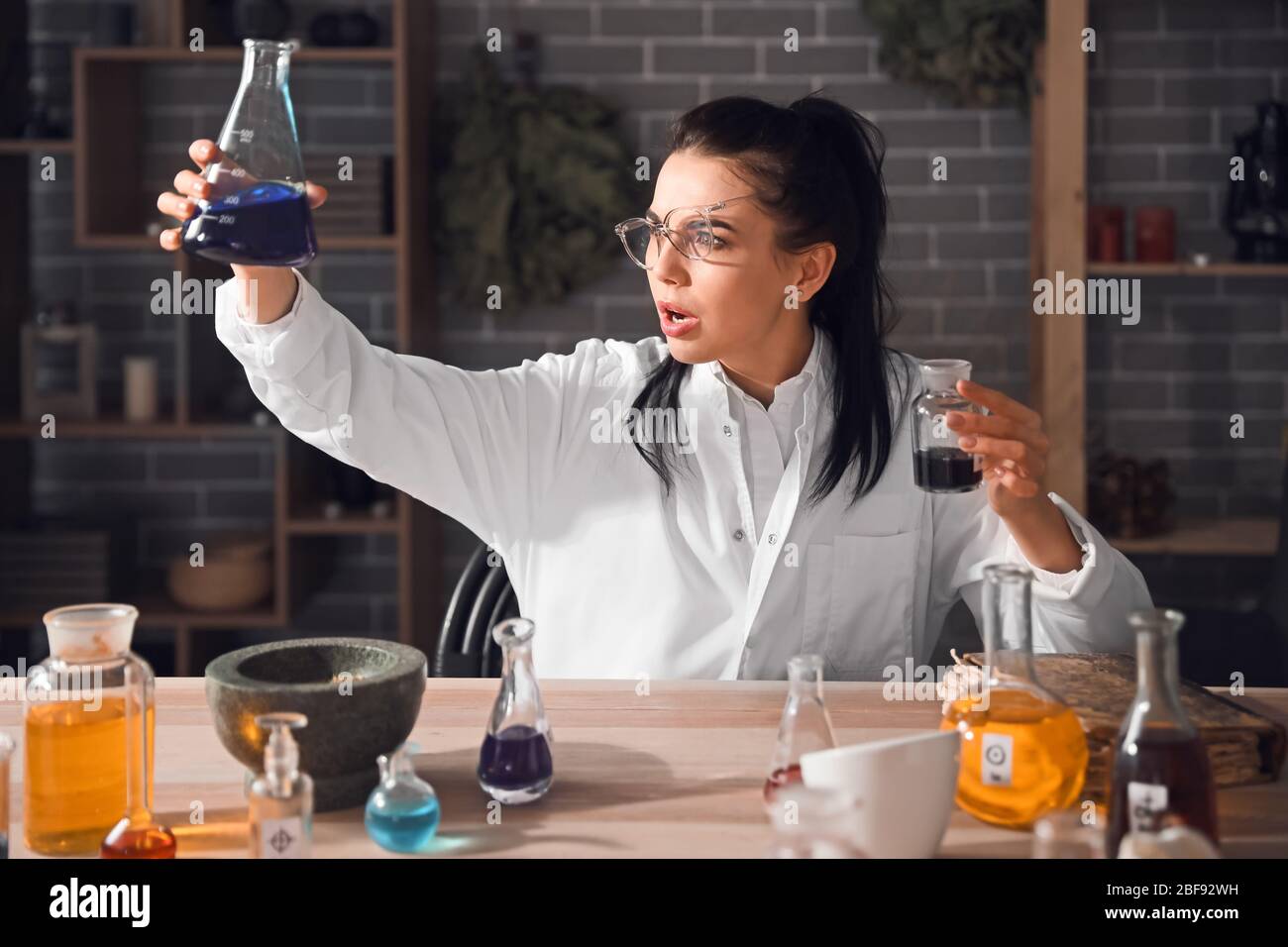 Crazy alchemist working in laboratory Stock Photo