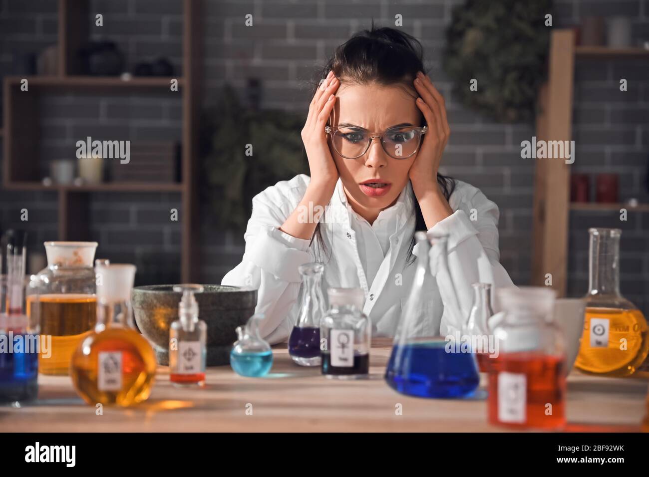 Crazy alchemist working in laboratory Stock Photo