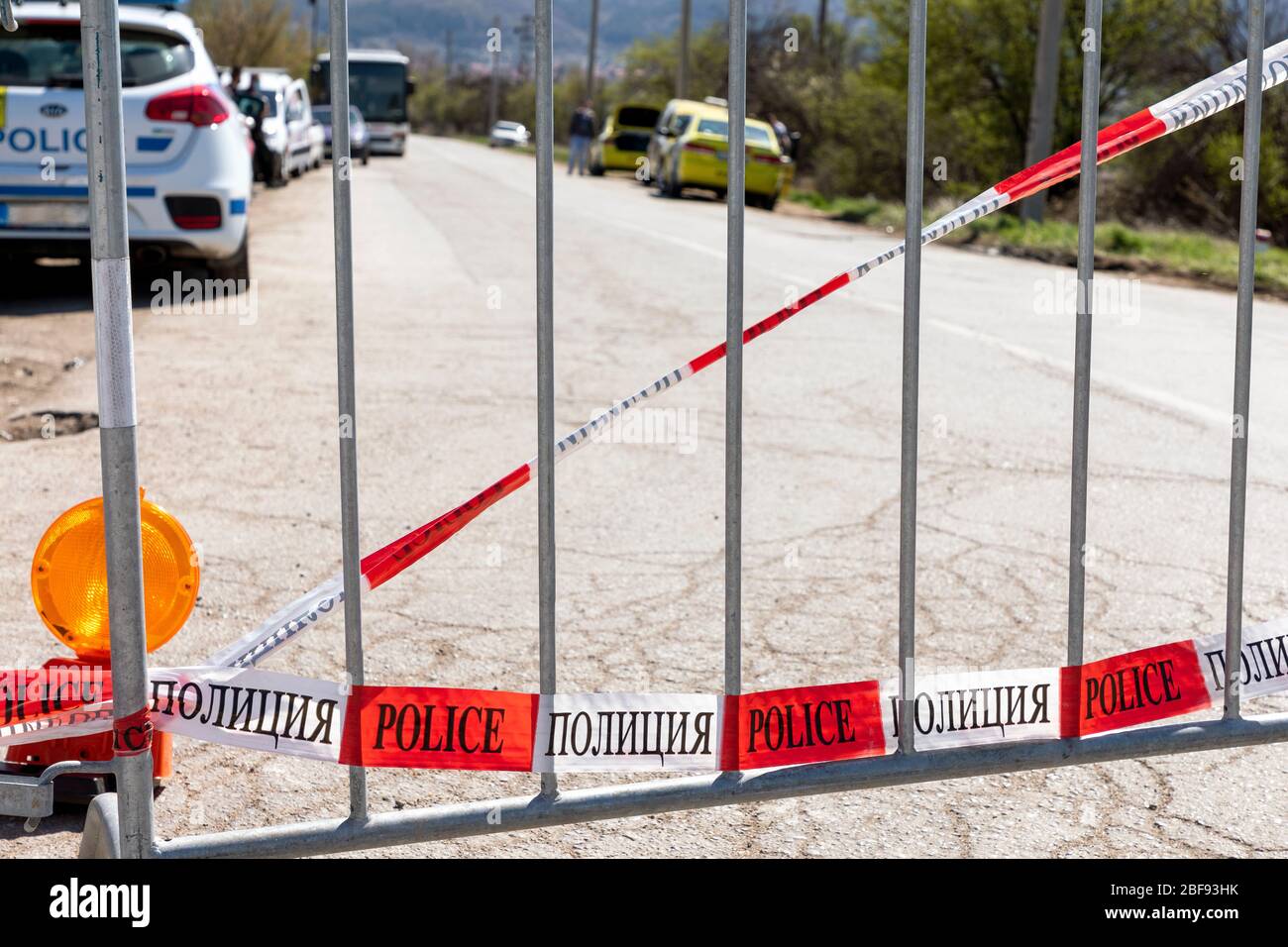 Red and white police tape with text police line does not cross a bend