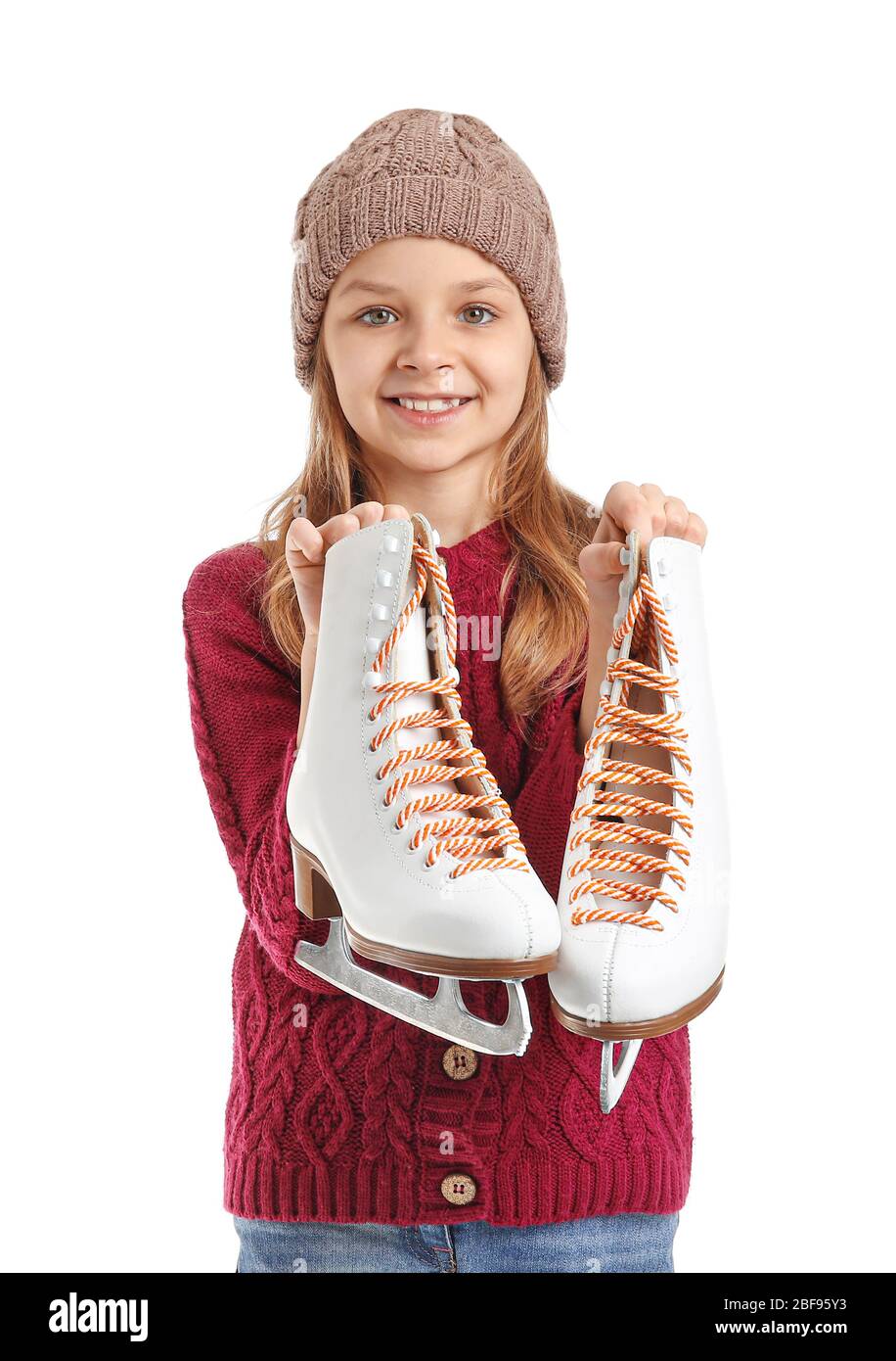 Cute little girl with ice skates on white background Stock Photo Alamy