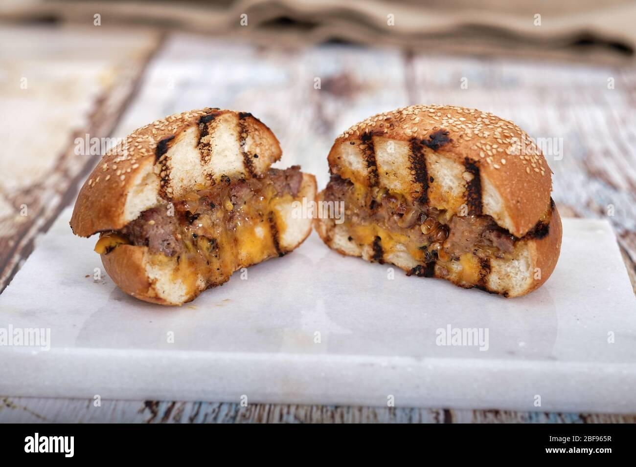 Fast Food, Hamburger. Special veal prepared hamburger, french fries and double cheddar cheese. Close-up fresh delicious tasty homemade burger. Stock Photo