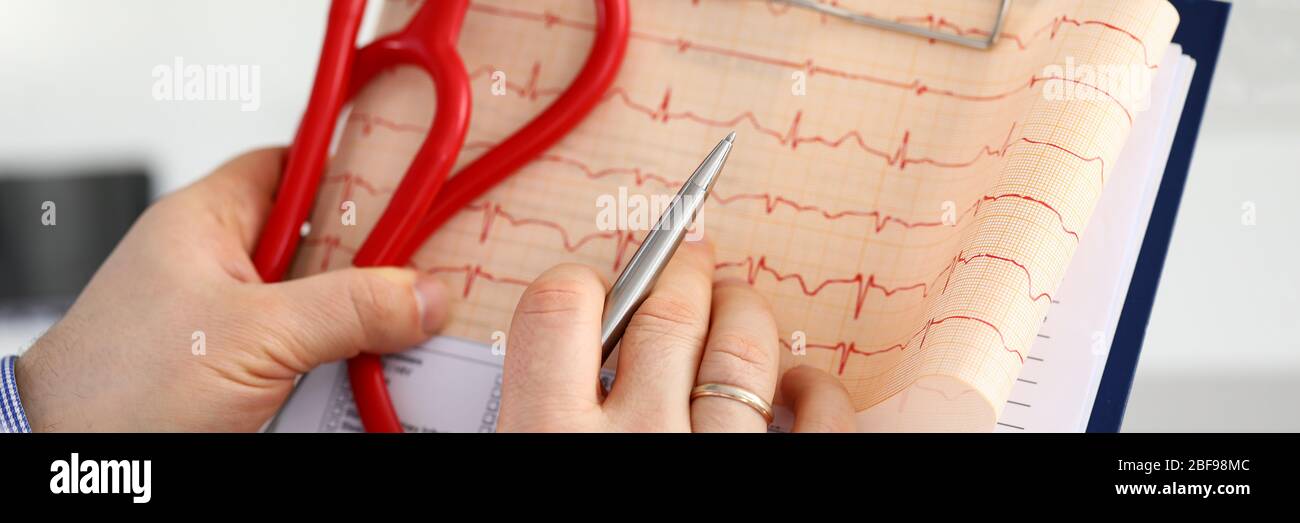 Male medicine doctor hands holding cardiogram chart Stock Photo - Alamy
