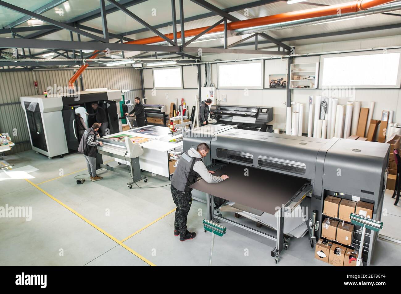 Large group of worker printmaker technician operator works in digital printing press hall and printshop office with many type of machine Stock Photo - Alamy