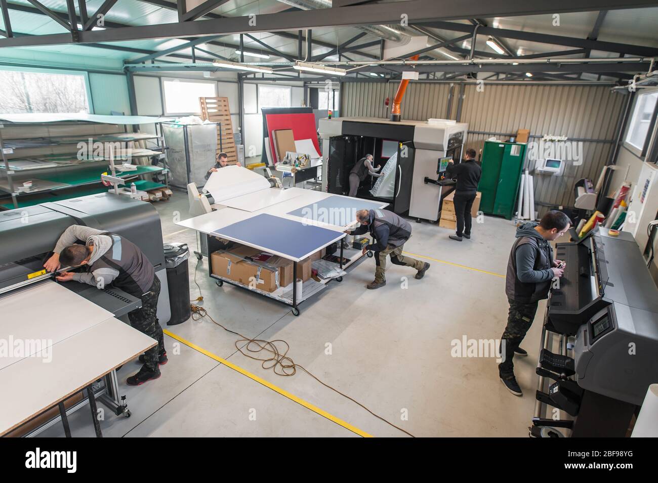 Large group of worker printmaker technician operator works in digital