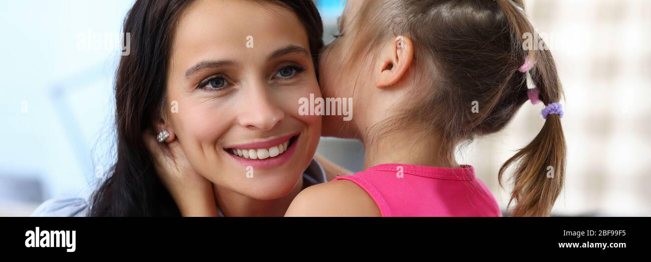 Child hugging cheerful mommy Stock Photo