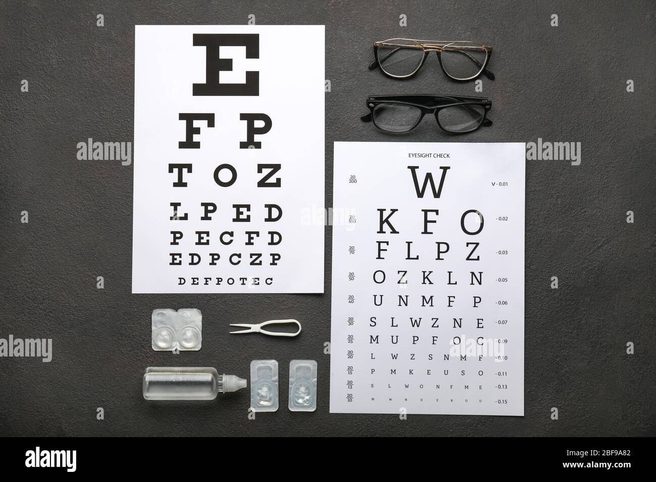 Eye test charts with eyeglasses, containers for contact lenses