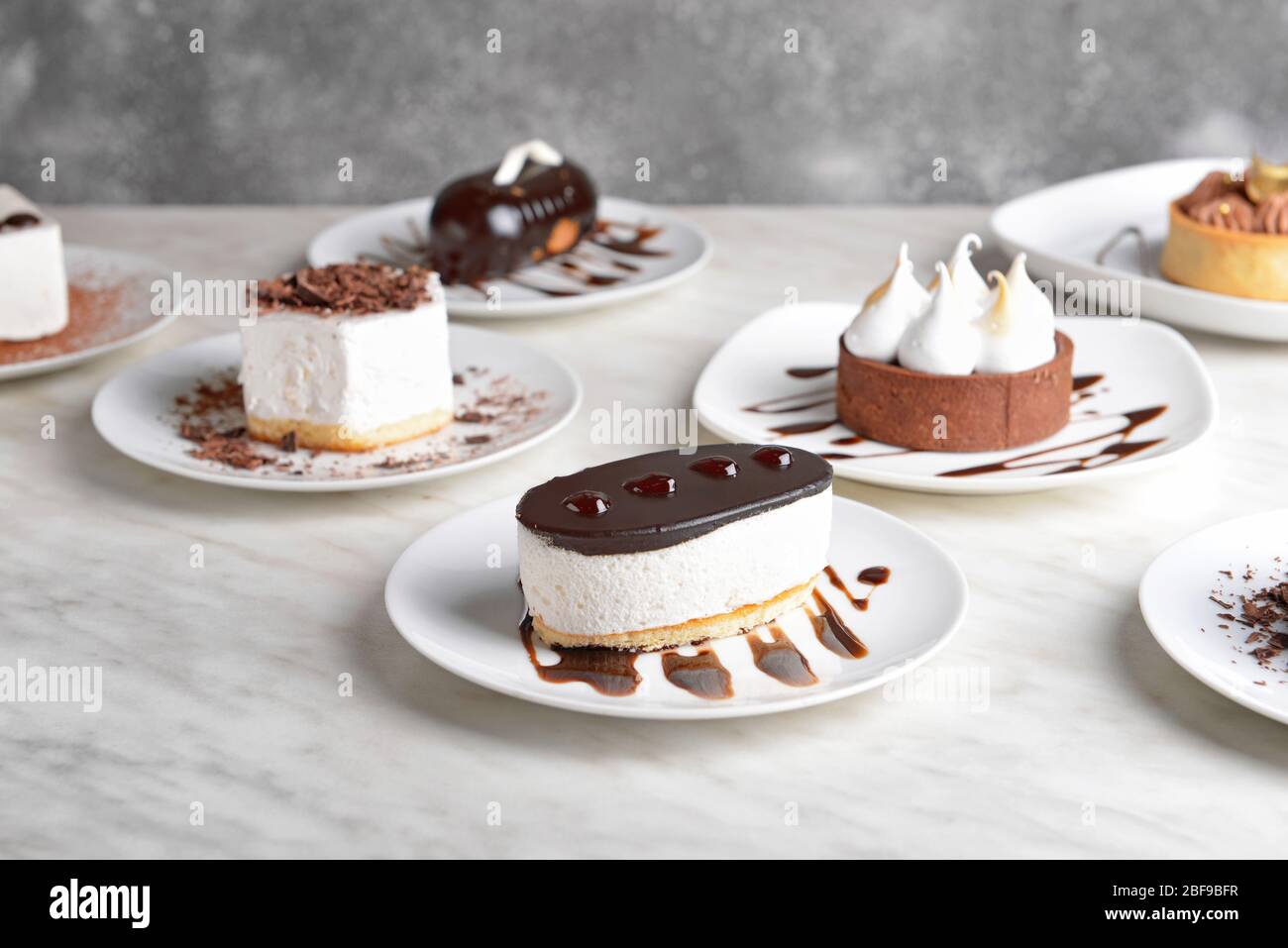 Tasty cakes on white table Stock Photo