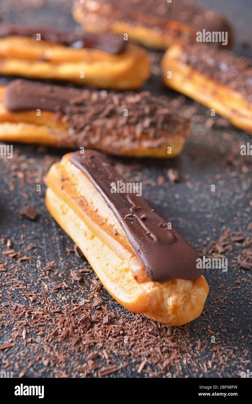 Tasty chocolate eclair on dark background Stock Photo