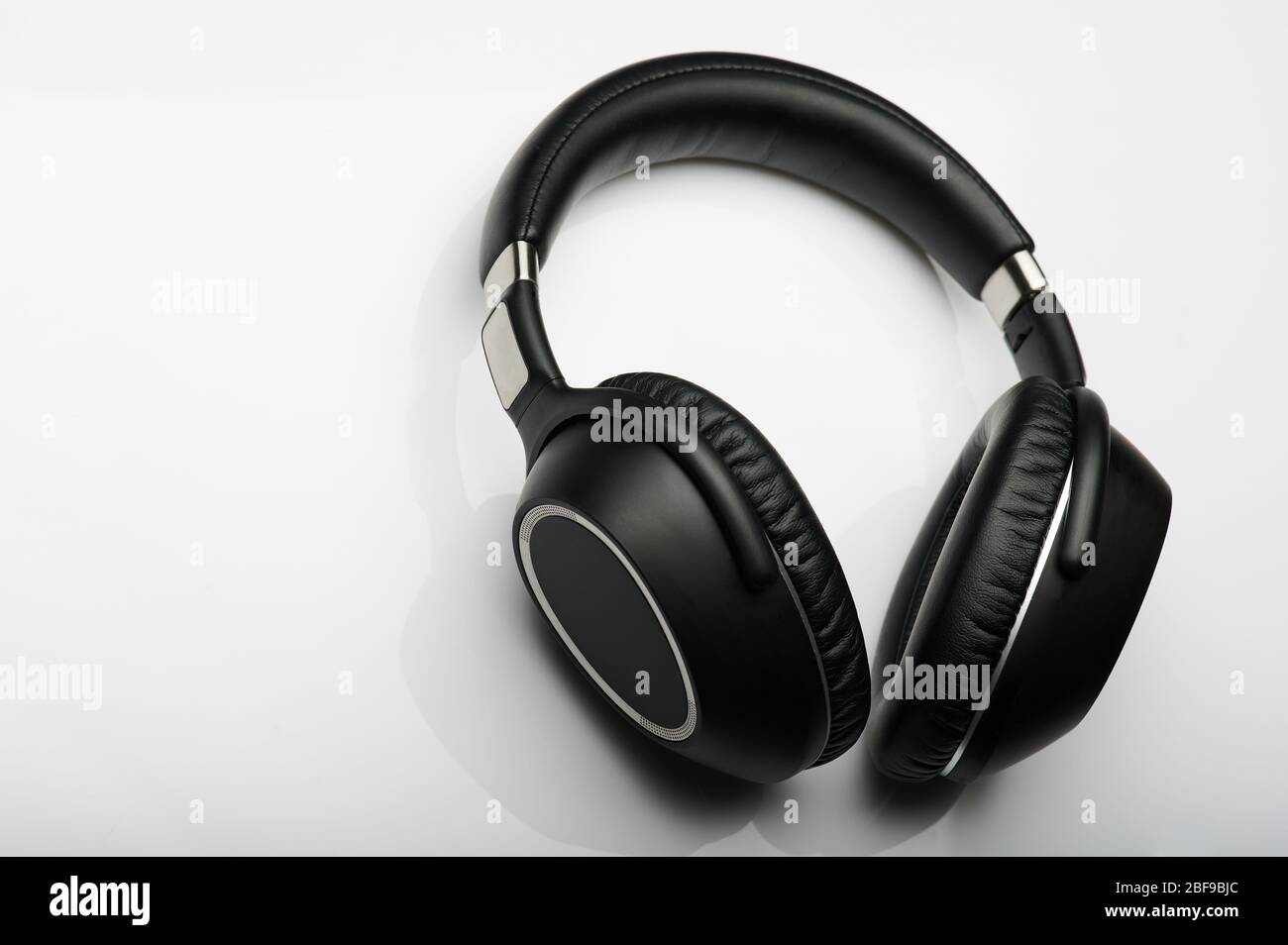 Black leather modern headphones isolated on white background Stock