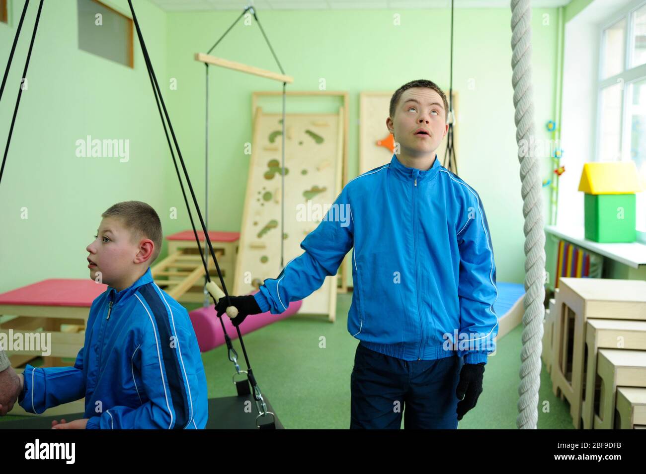 Improving motor control Down syndrome boy doing exercises at the