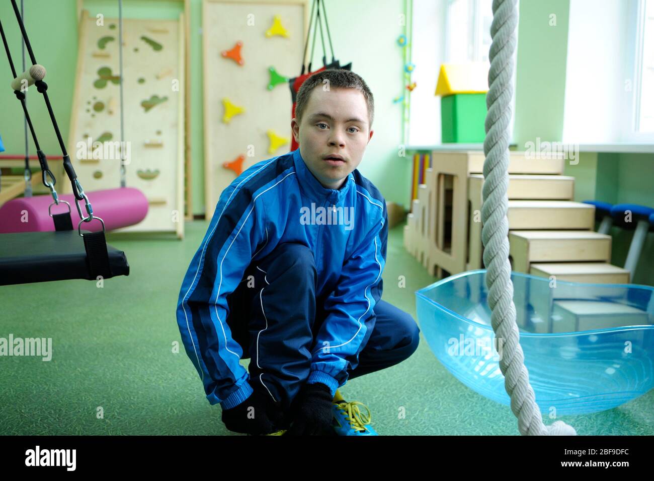 Improving motor control Down syndrome boy doing exercises at the