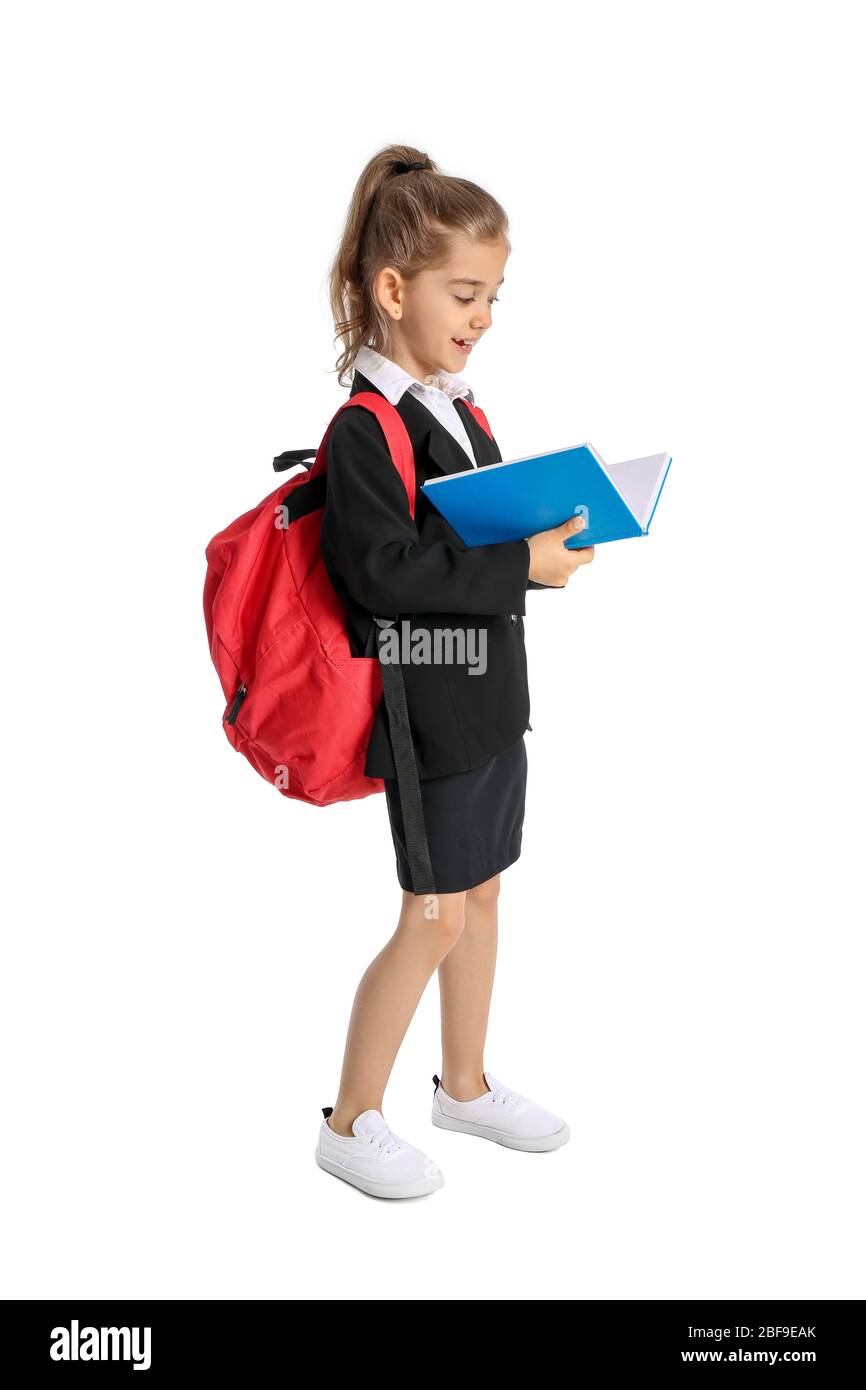 Cute little schoolgirl with book on white background Stock Photo - Alamy