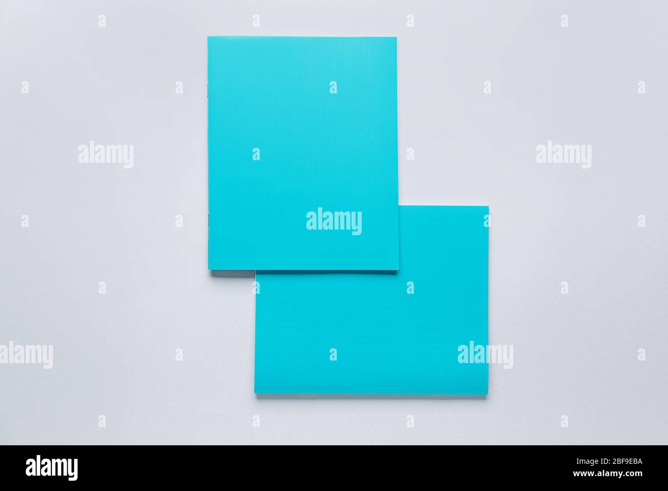 Two notebooks on grey background Stock Photo