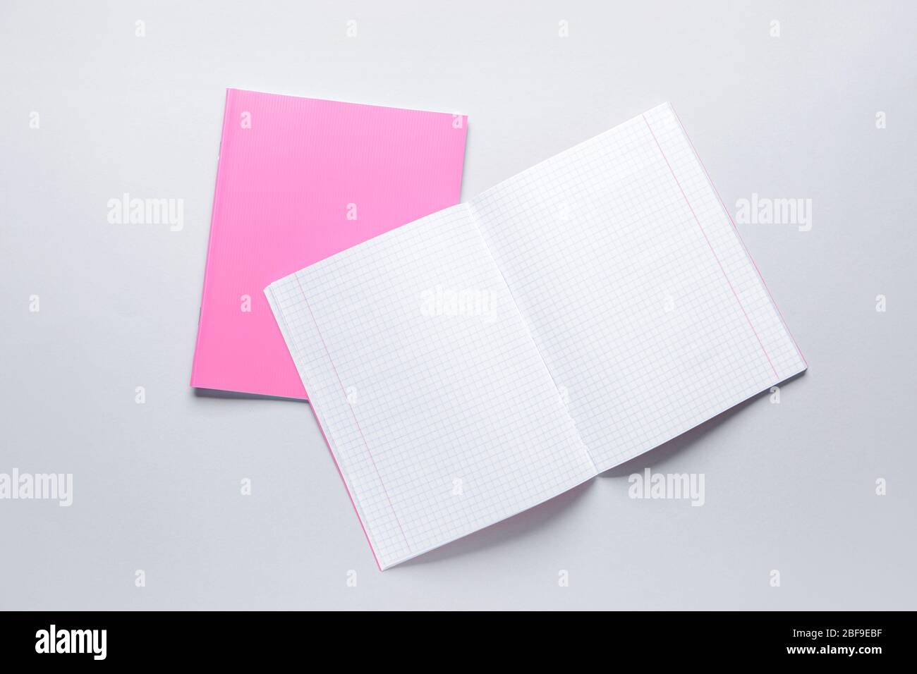 Two notebooks on grey background Stock Photo