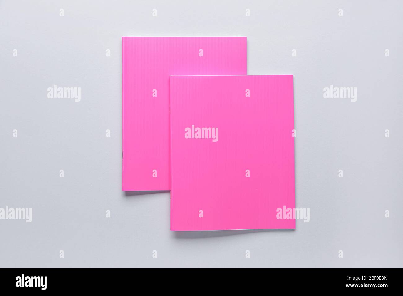 Two notebooks on grey background Stock Photo