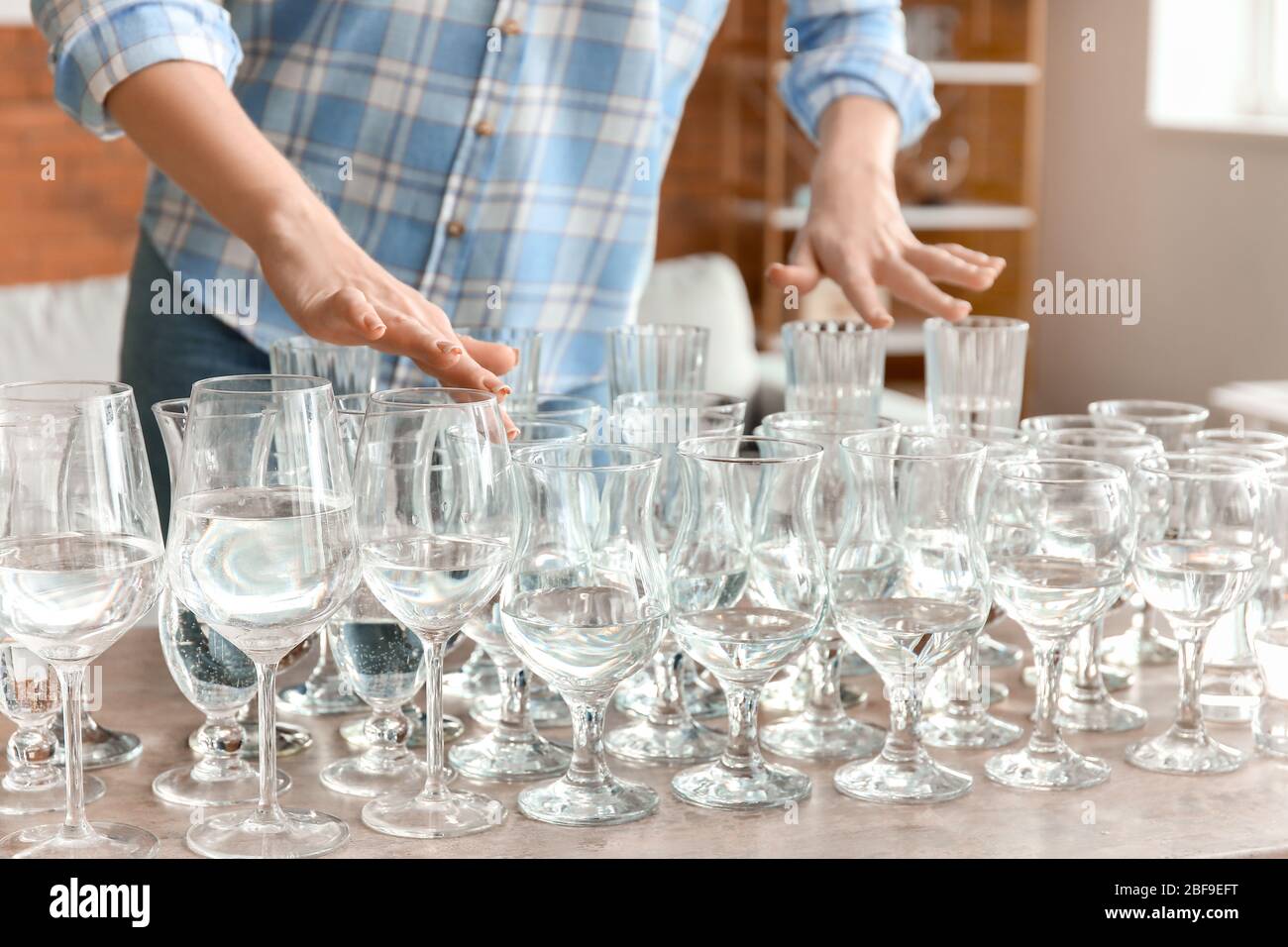 https://c8.alamy.com/comp/2BF9EFT/young-woman-playing-music-on-glasses-with-water-at-home-2BF9EFT.jpg