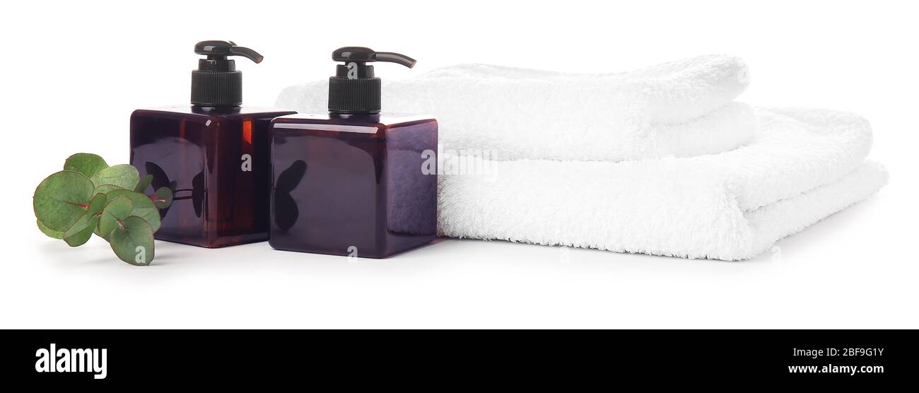 Shampoo and towels on white background Stock Photo