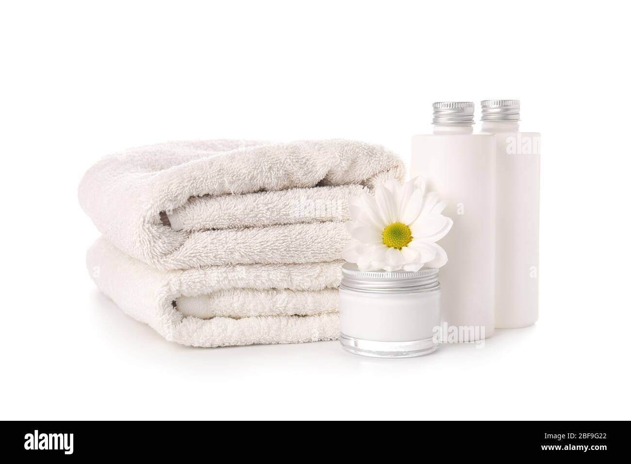 Shampoo, cream and towels on white background Stock Photo