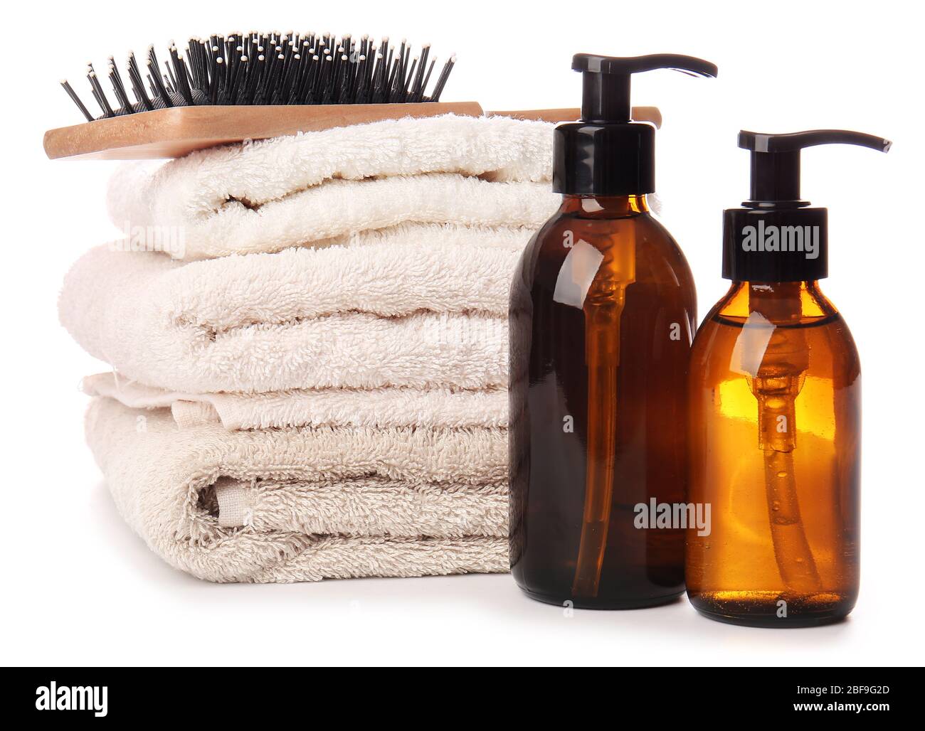 Shampoo, brush and towels on white background Stock Photo