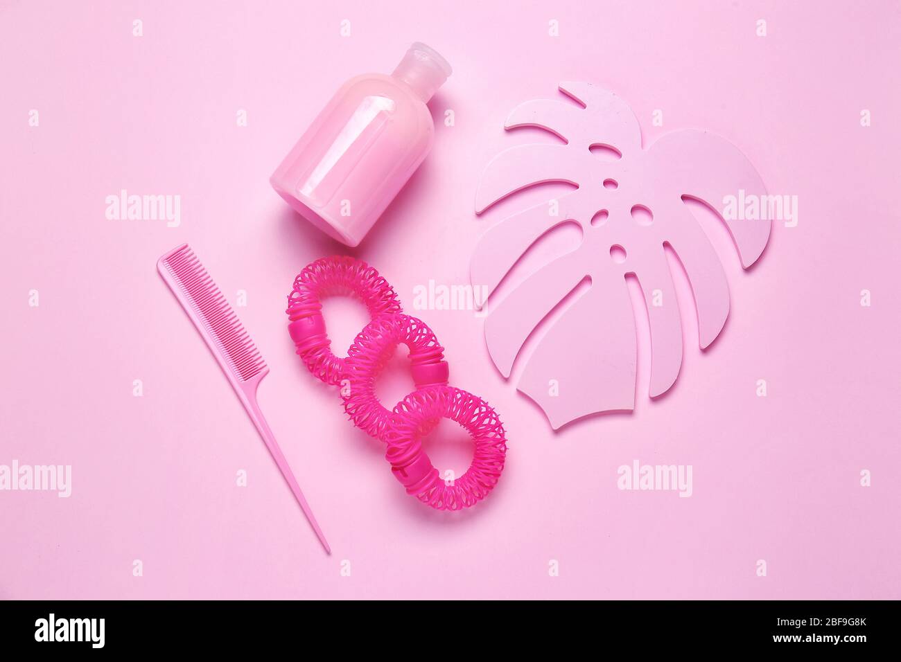Composition with shampoo, hair ties and comb on color background Stock Photo