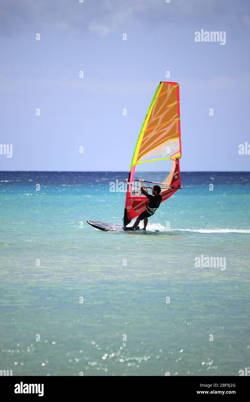 Costa Calma, Spain - May 13, 2019: Surfer in Sotavento Beach in Fuerteventura. Canary Islands, Spain Stock Photo