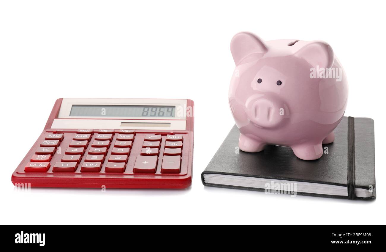 Calculator with piggy bank and notebook on white background Stock Photo ...