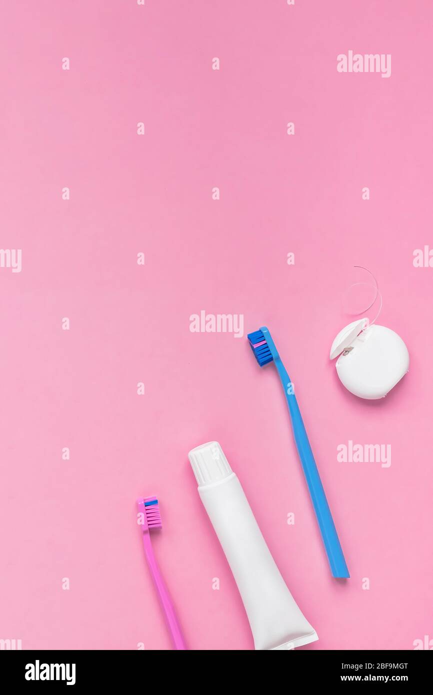 Teeth hygiene and oral dental care products on color pink and blue ...