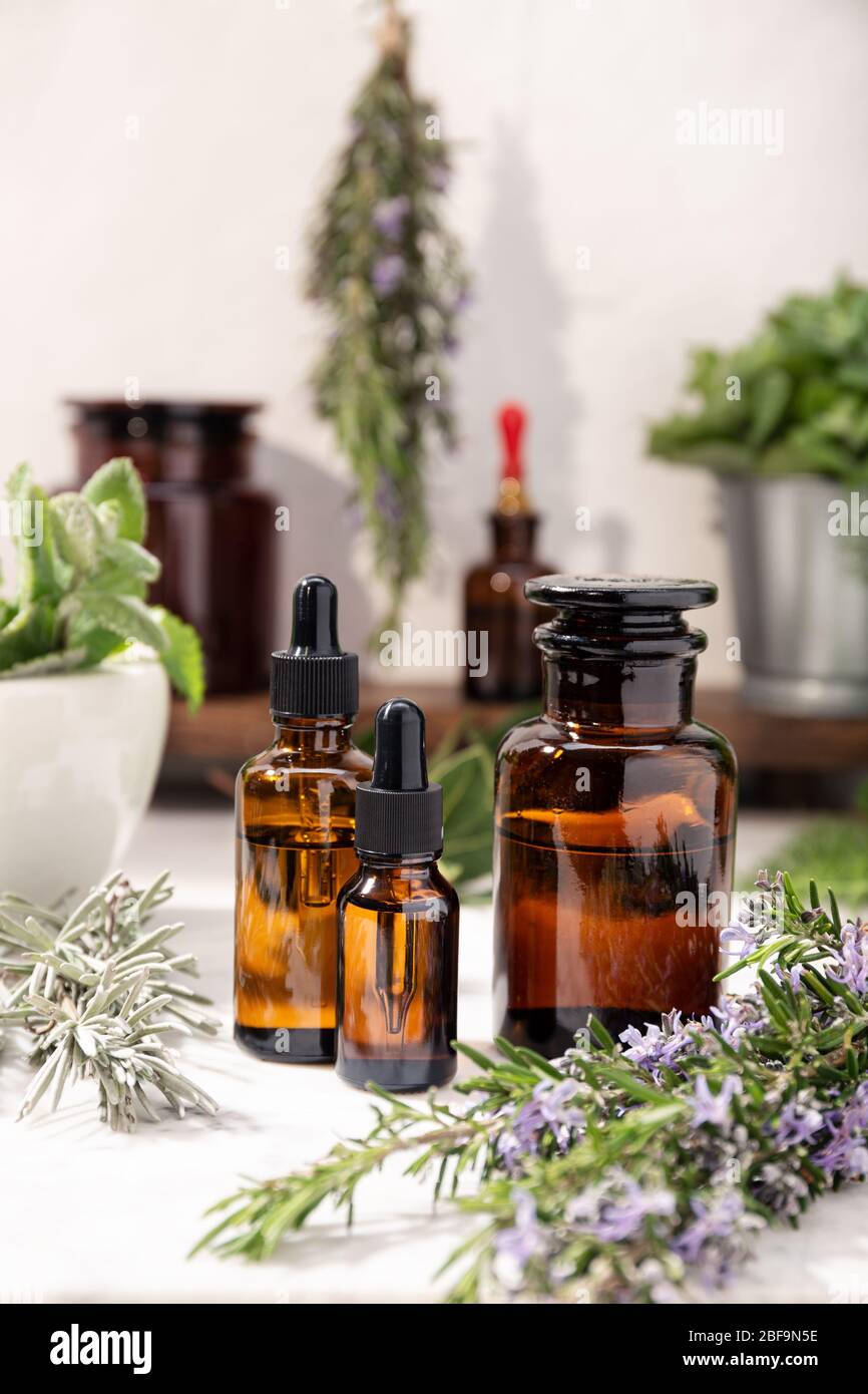 Herbal essential oil on vintage apothecary bottles. herbal oil for skin care, aromatherapy and natural medicine Stock Photo