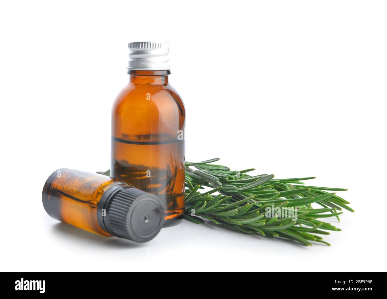 Bottles of rosemary essential oil on white background Stock Photo - Alamy