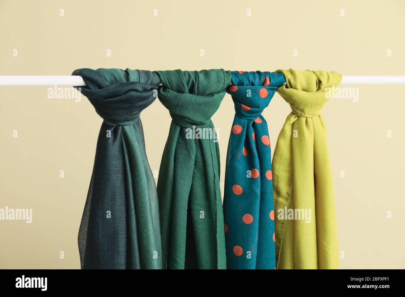 Different beautiful scarves hanging on rack Stock Photo Alamy