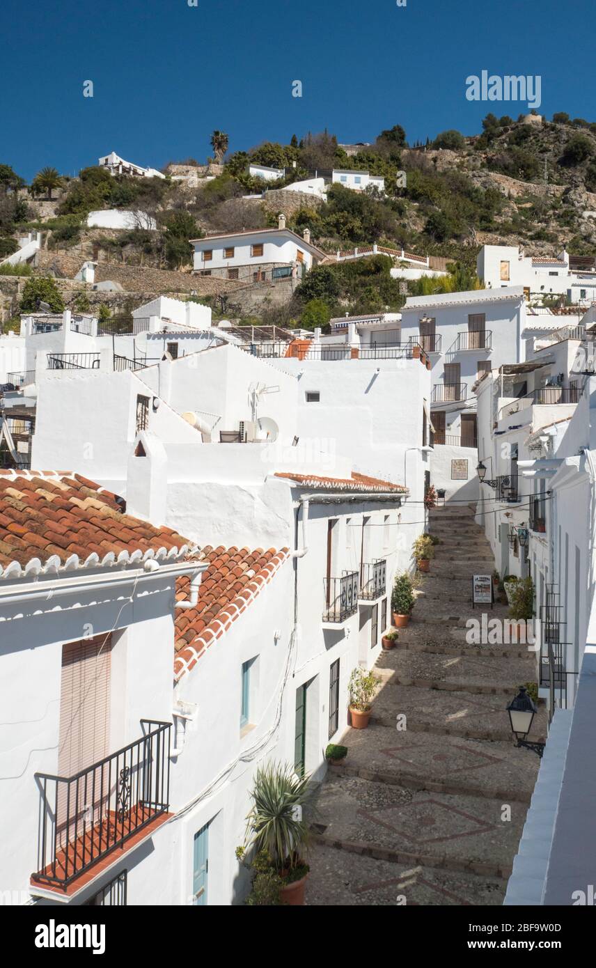 Street scene in Frigiliana, Andalusia, Spain, built on a hillside with white buildings. Stock Photo