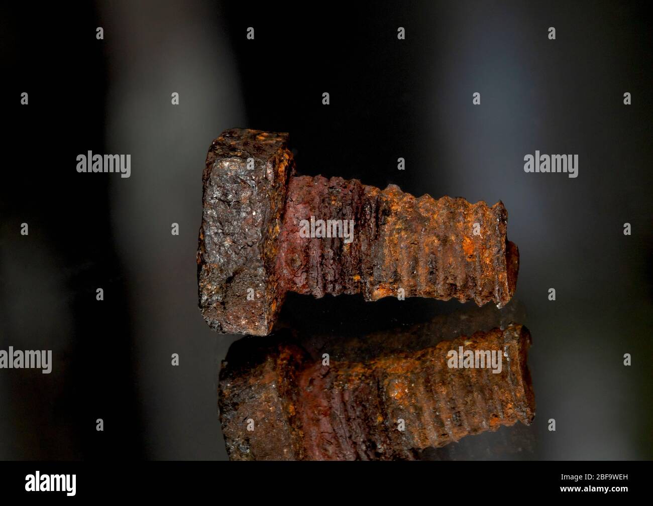 Rusted screw closeup view on black background Stock Photo
