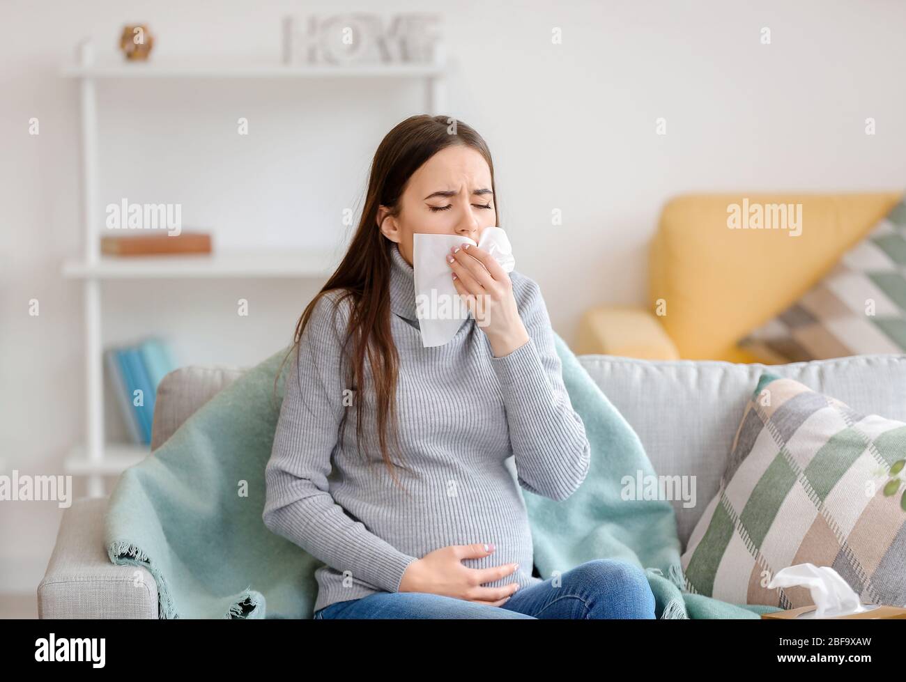 Coughing pregnant woman at home Stock Photo Alamy
