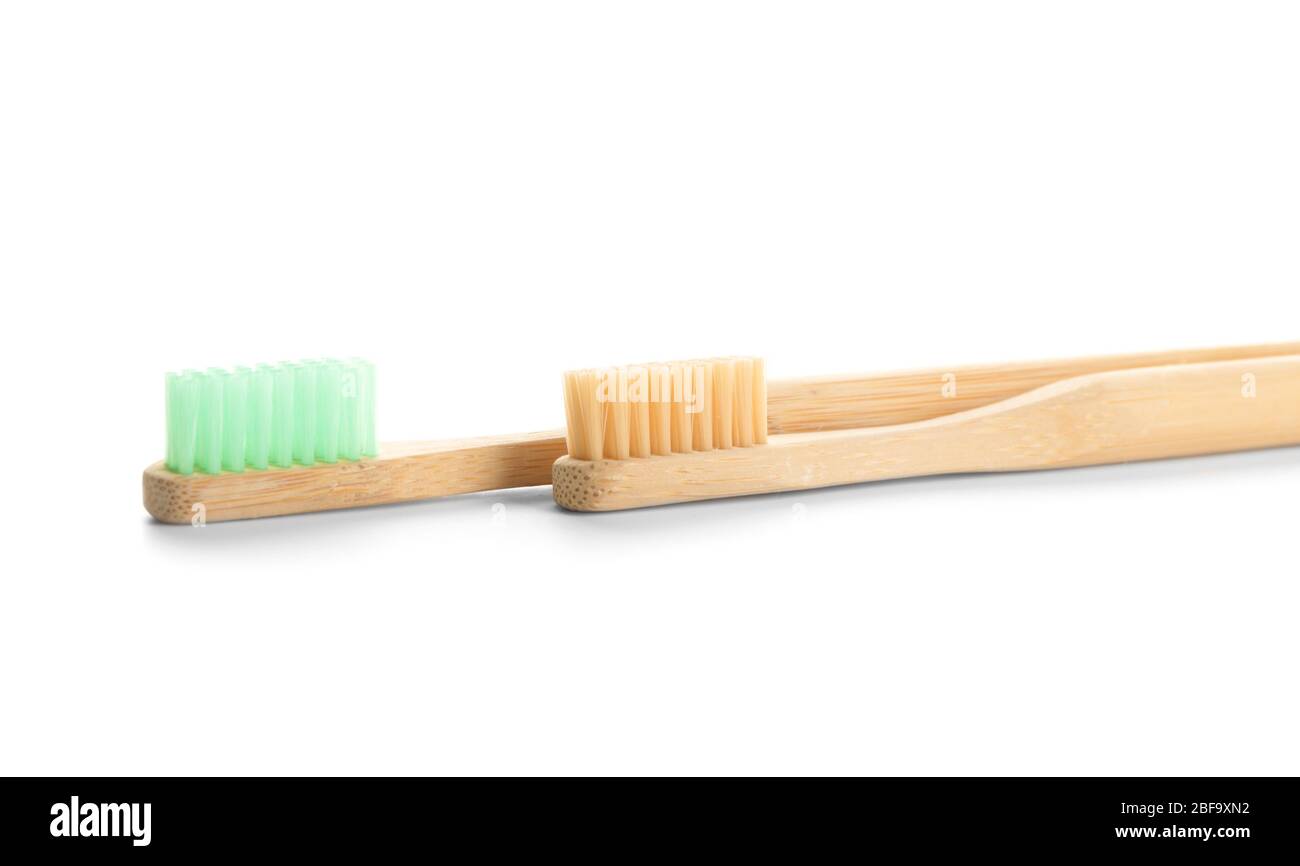 Wooden tooth brushes on white background Stock Photo - Alamy